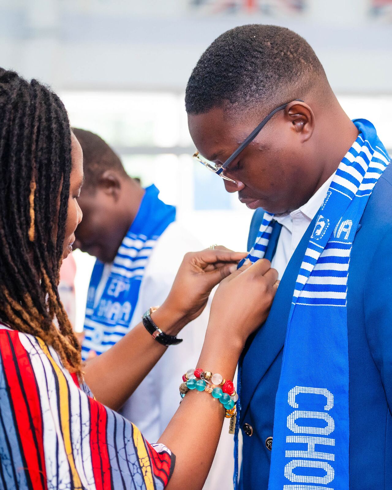 A new Fellow having an EPL Ghana sash pinned on at induction